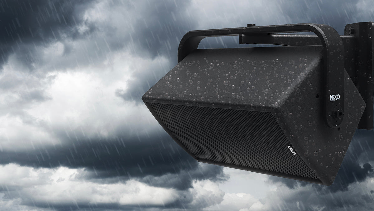 NEXO ePS outdoor speaker on a wall bracket in the rain, illustrating weather resistance