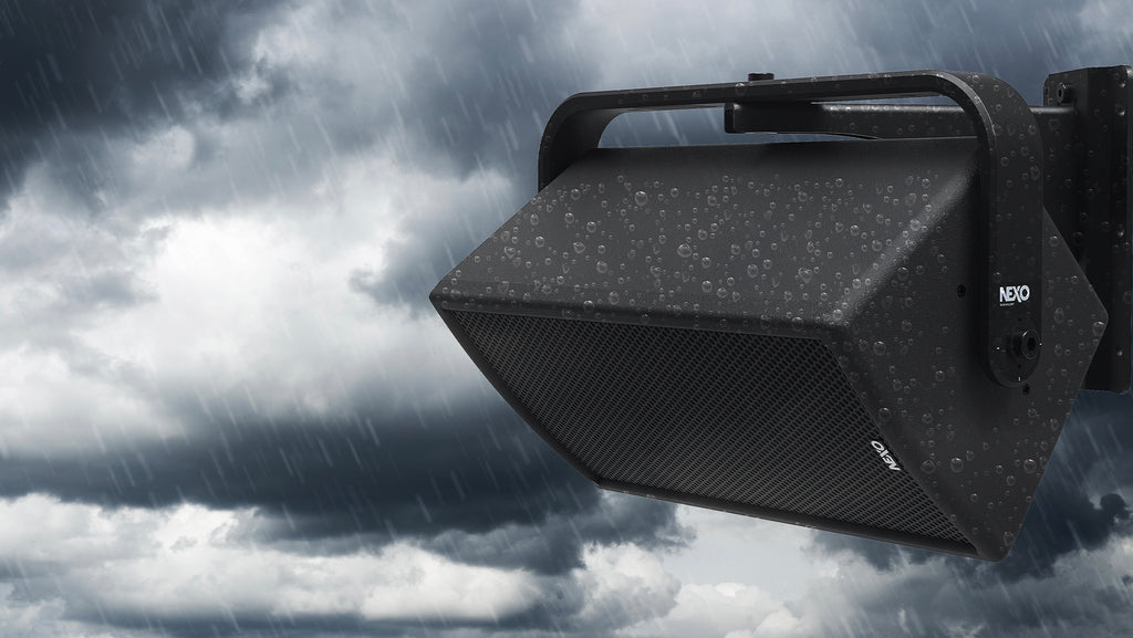 NEXO ePS outdoor speaker on a wall bracket in the rain, illustrating weather resistance